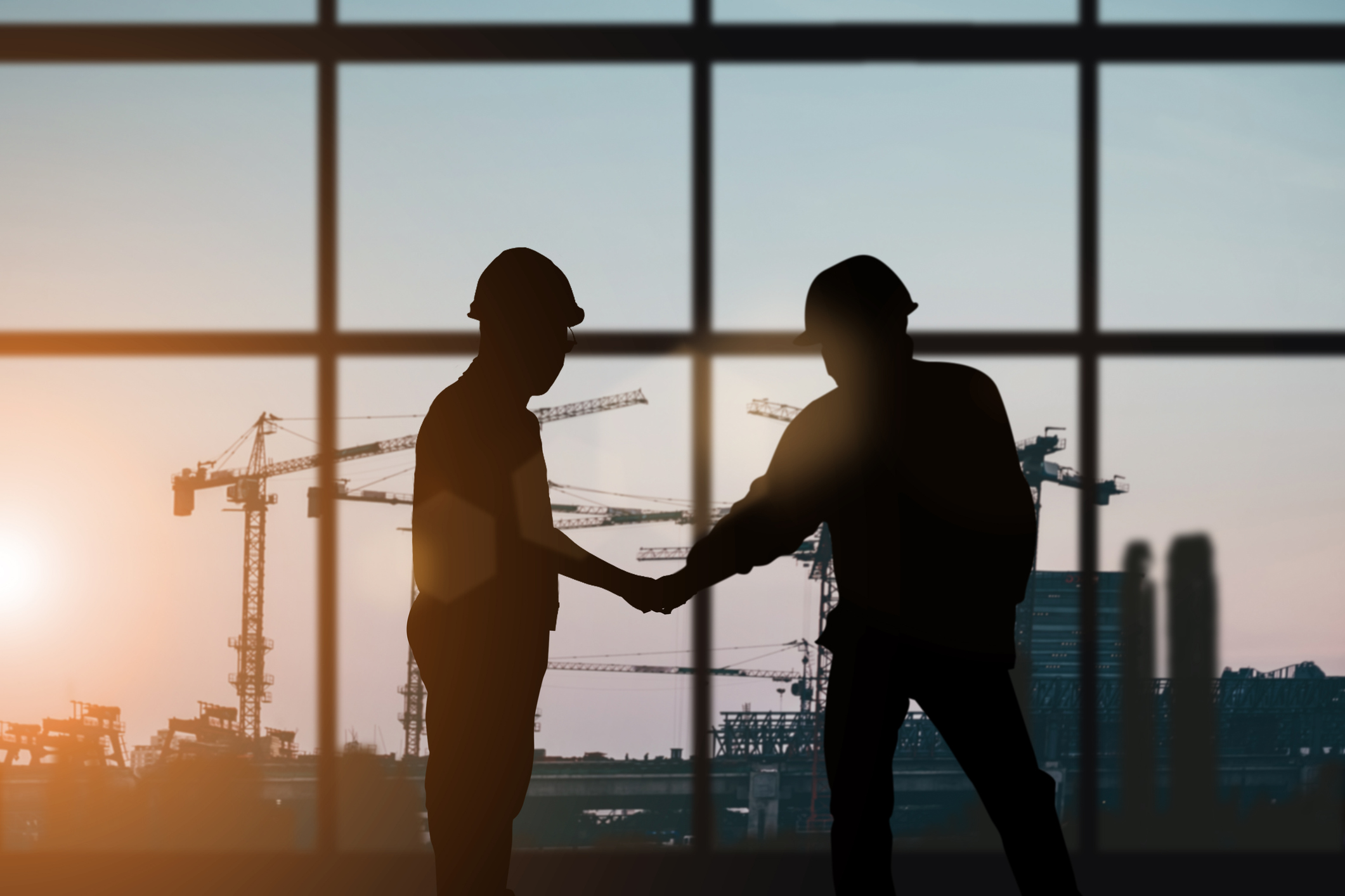 Silhouette of engineer and construction team working at site over blurred background for industry background with Light fair.Create from multiple reference images together